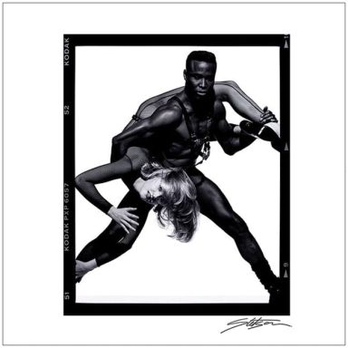 A dynamic black and white portrayal of a male and female dancer in an expressive pose.