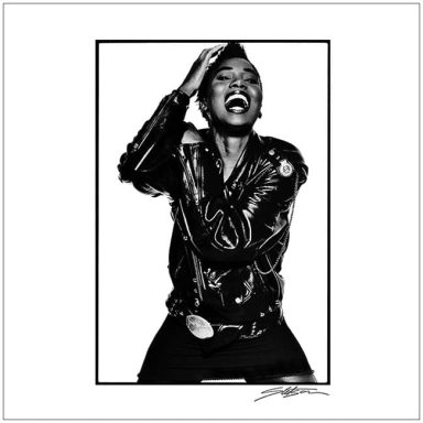 A person in a black leather jacket striking an expressive pose with a joyful expression.