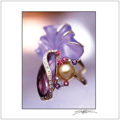 A decorative ring featuring a purple leaf design, a pearl, and gem accents.