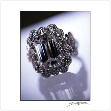 Elegant ring with a large central stone surrounded by smaller sparkling gems.